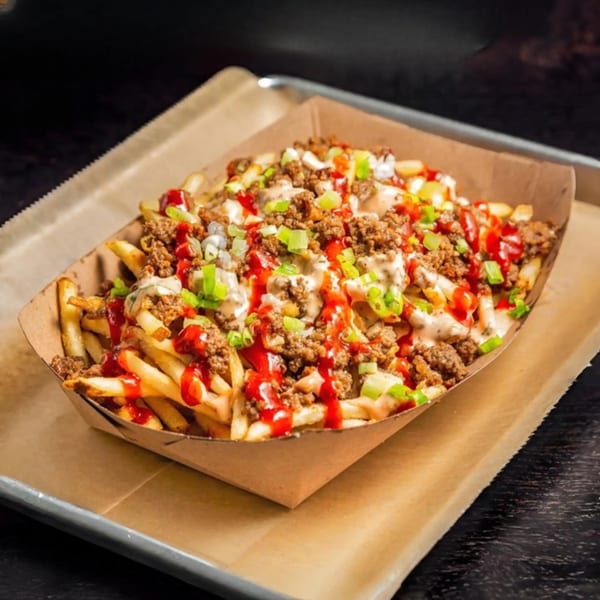 Tampa Burger Company's loaded fries with ground beef, ketchup, white sauce, and green onions.